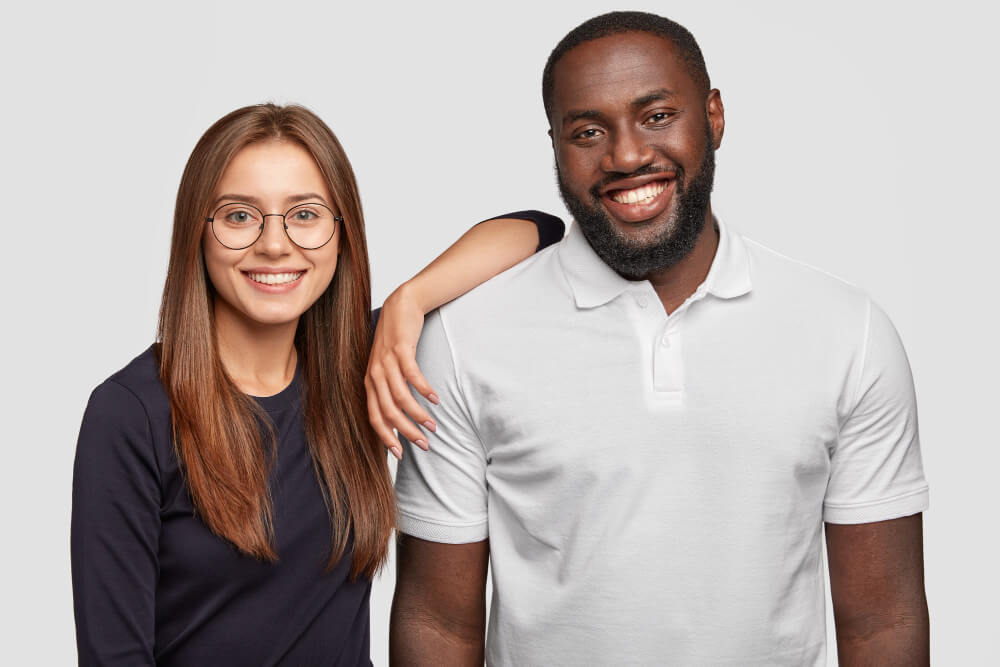 race awareness training Black male and white woman smiling next to each other
